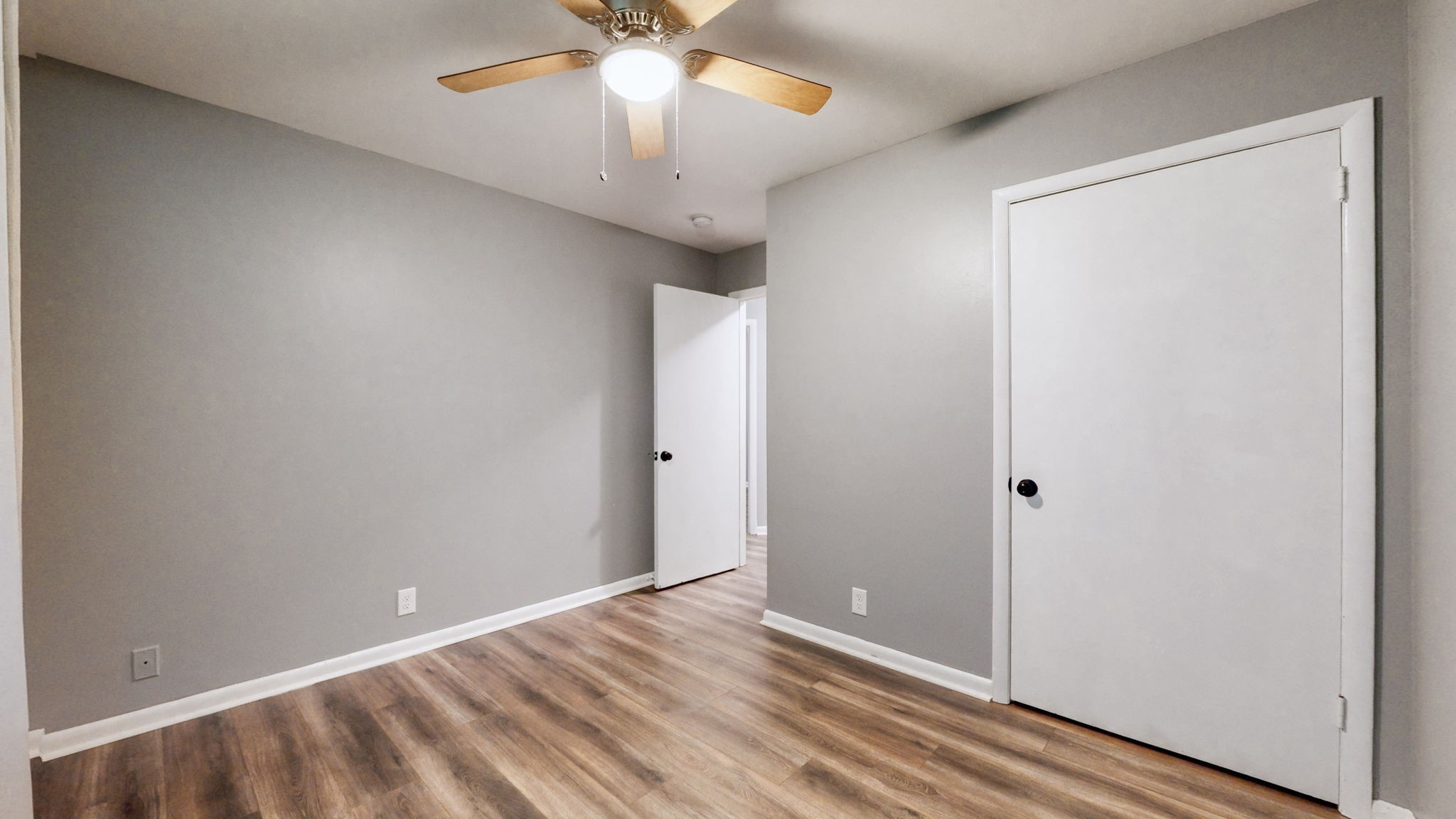 1214 Rutherford Street Murfreesboro, TN 37130 - Photo 20 of 37 an empty room with wooden floor and chandelier fan