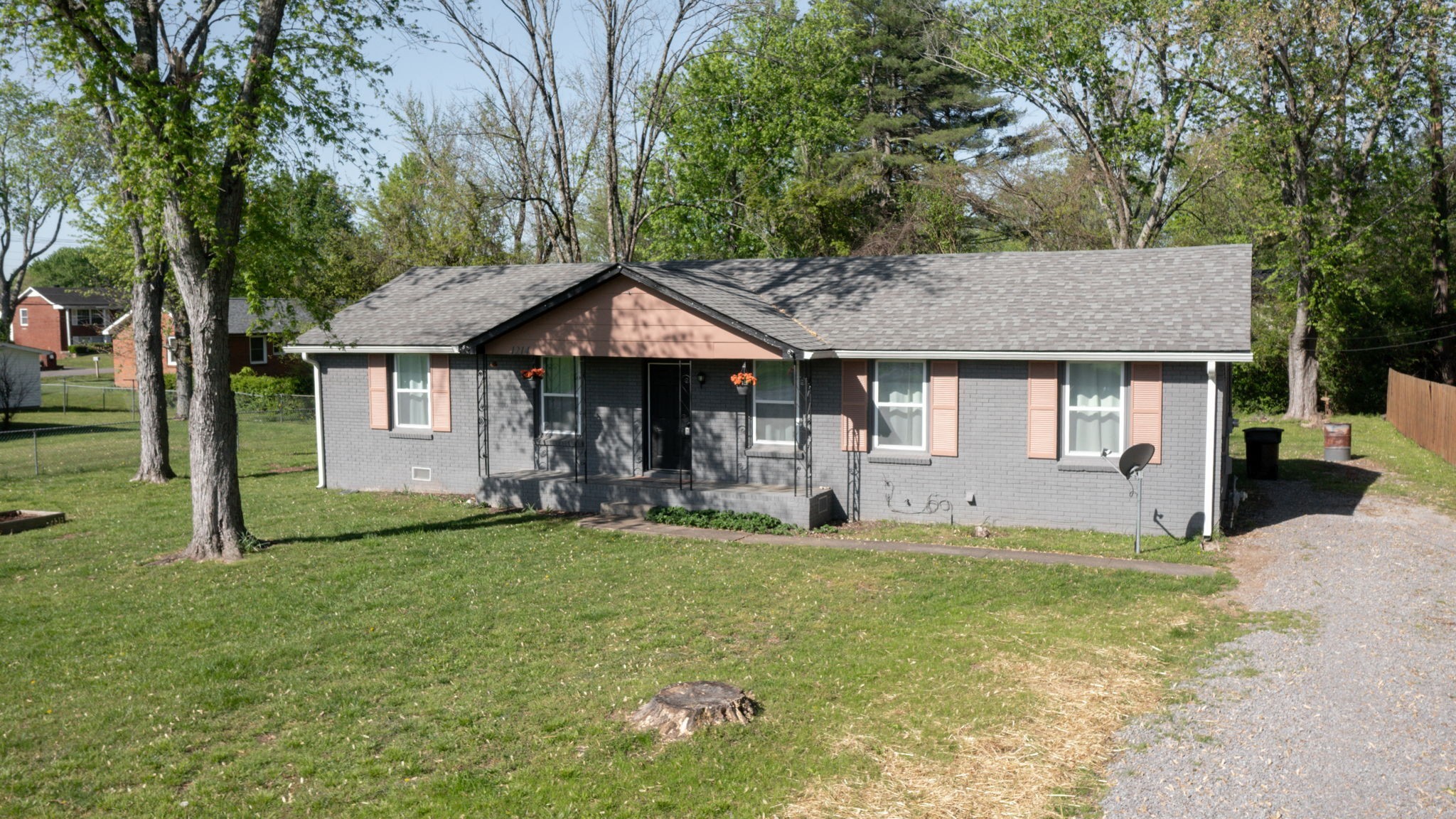 1214 Rutherford Street Murfreesboro, TN 37130 - Photo 2 of 37 a front view of a house with a garden and trees