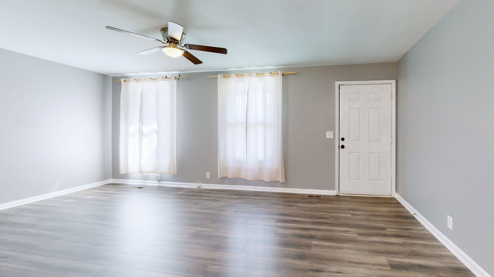 1214 Rutherford Street Murfreesboro, TN 37130 - Photo 8 of 37 an empty room with wooden floor fan and windows
