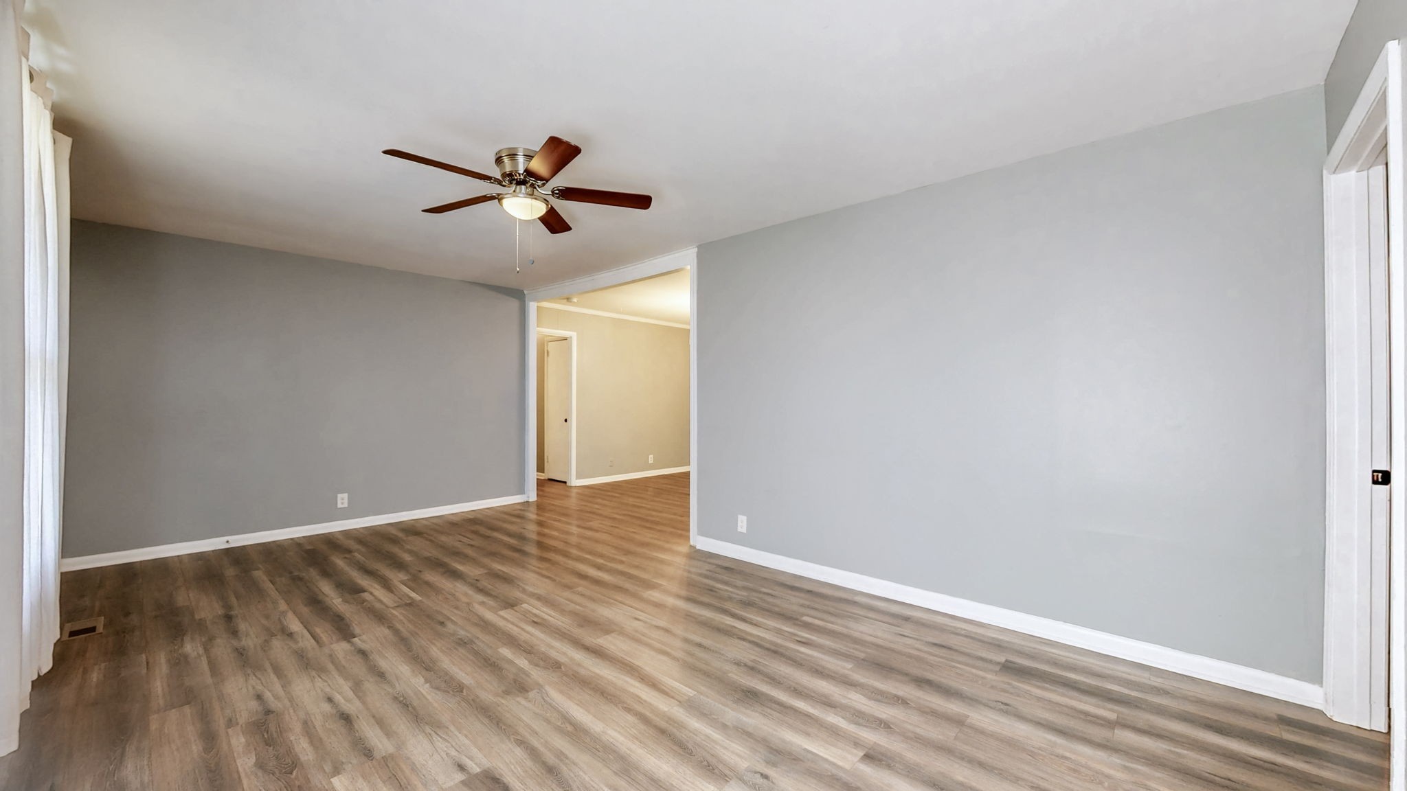1214 Rutherford Street Murfreesboro, TN 37130 - Photo 9 of 37 a view of a room with wooden floor and a ceiling fan