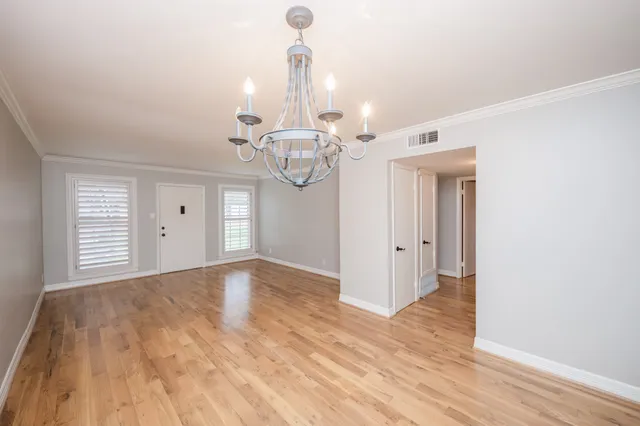 a view of a room with wooden floor