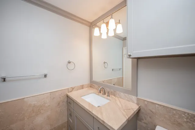 a bathroom with a sink vanity and a mirror