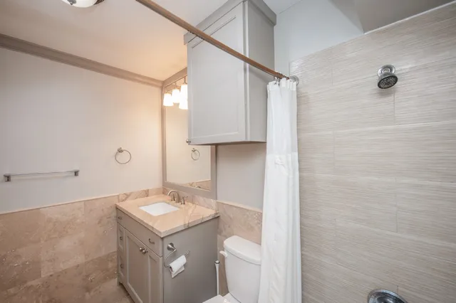 a bathroom with a sink toilet and shower