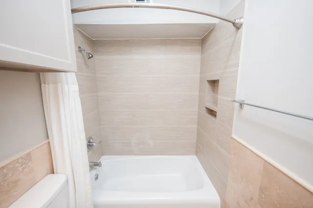 a bathroom with a bathtub and a shower