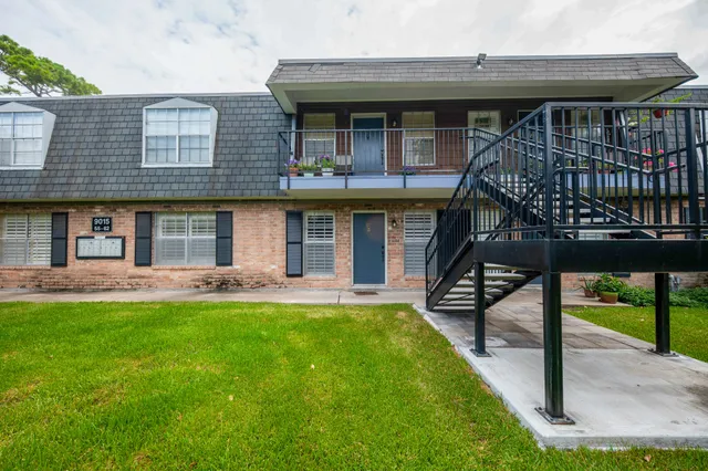 a front view of a house with a yard table and chairs