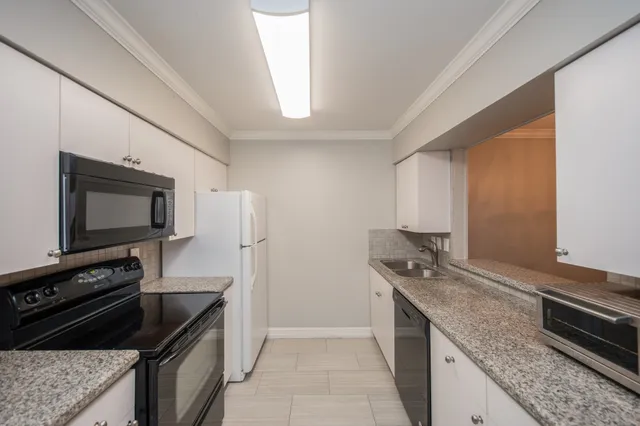 a kitchen with stainless steel appliances granite countertop a stove and a microwave