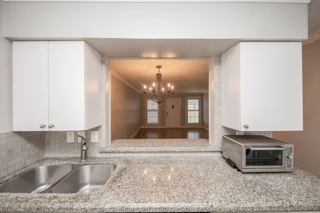a view of a kitchen with a sink and a refrigerator