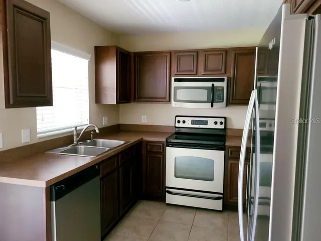 a kitchen with a stove and a microwave