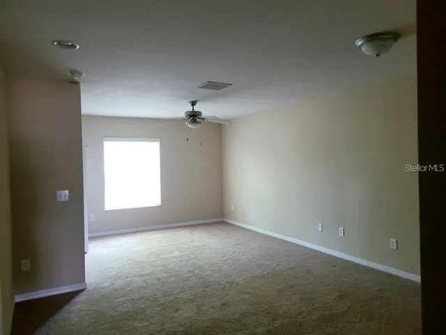 an empty room with a empty space and a window