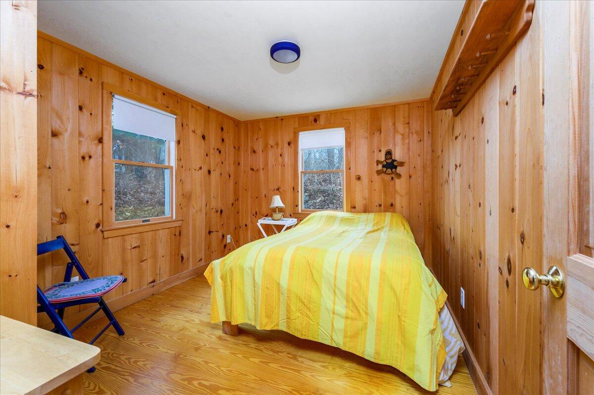 58 Oyster Pond Road Falmouth, MA 02540 - Photo 12 of 30 a bedroom with a bed and wooden floor