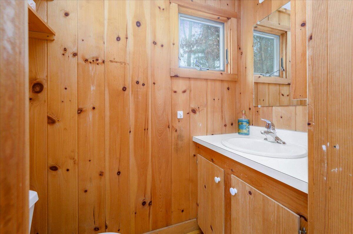 58 Oyster Pond Road Falmouth, MA 02540 - Photo 14 of 30 a bathroom with a sink and a mirror
