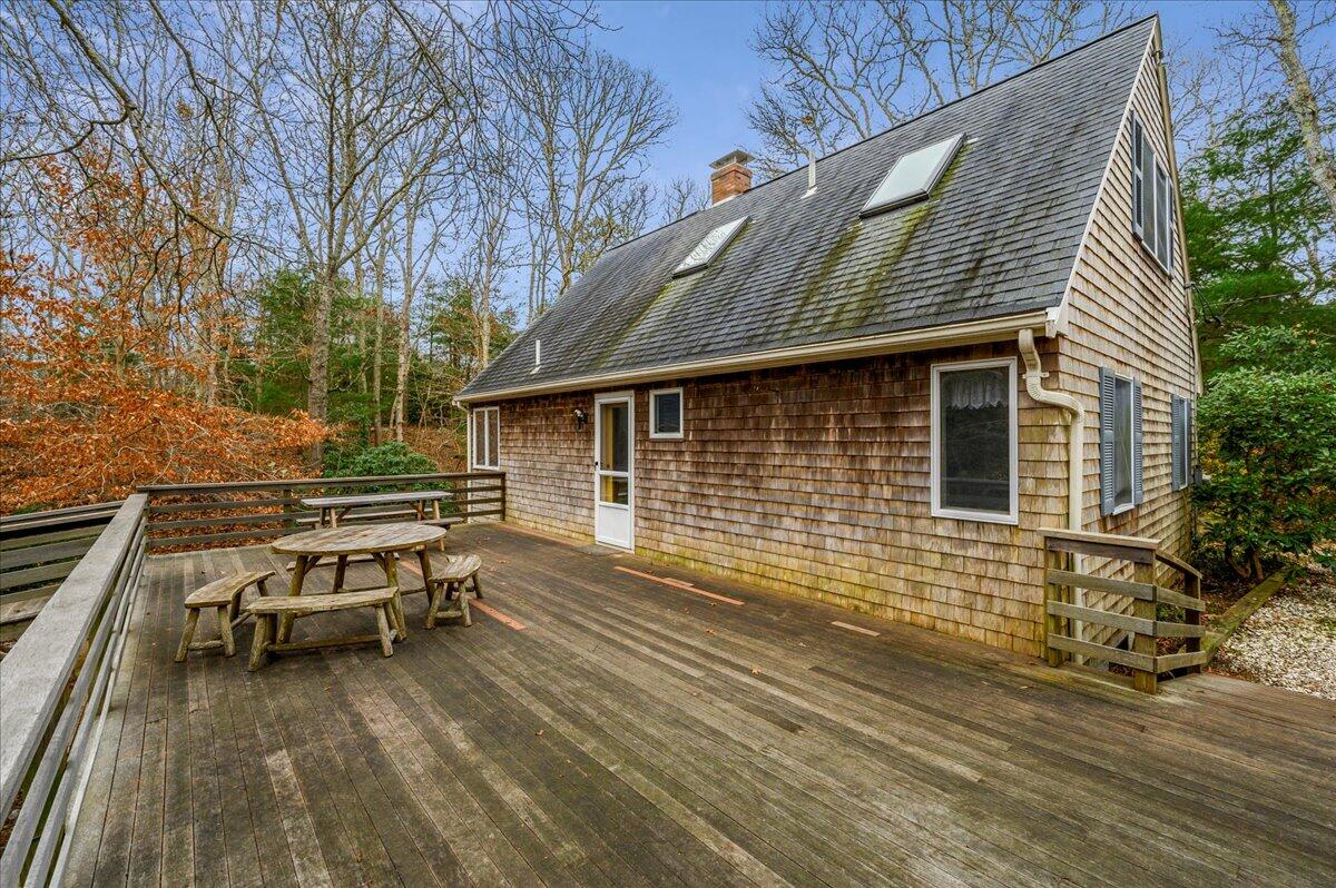 58 Oyster Pond Road Falmouth, MA 02540 - Photo 17 of 30 a backyard of a house with barbeque oven table and chairs