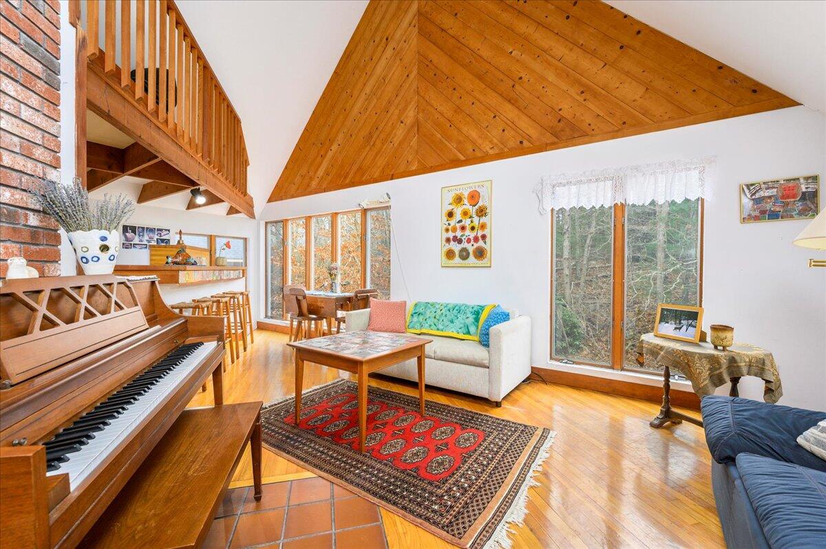 58 Oyster Pond Road Falmouth, MA 02540 - Photo 2 of 30 a living room with furniture a rug and a potted plant
