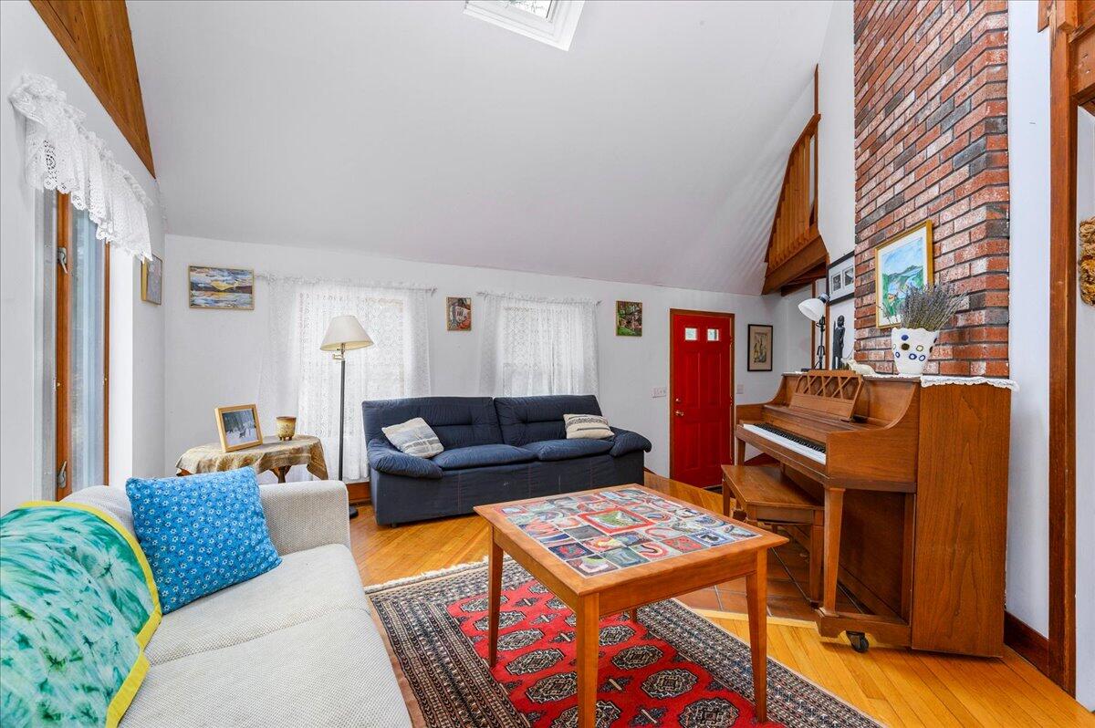 58 Oyster Pond Road Falmouth, MA 02540 - Photo 3 of 30 a living room with furniture a rug and a window