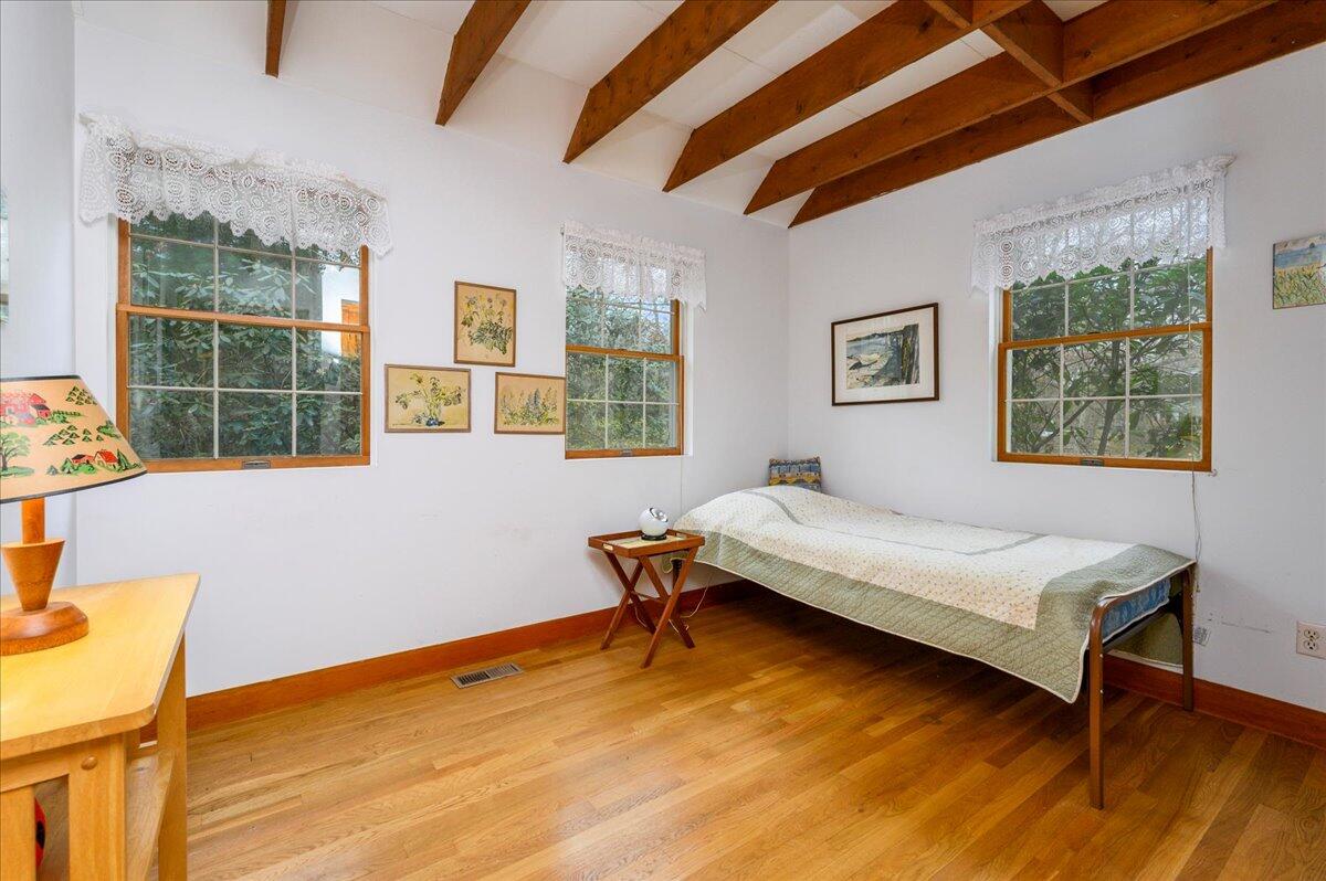58 Oyster Pond Road Falmouth, MA 02540 - Photo 5 of 30 a bedroom with a bed wooden floor and window