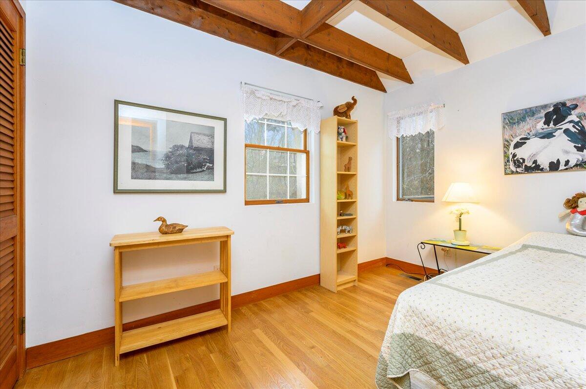 58 Oyster Pond Road Falmouth, MA 02540 - Photo 6 of 30 a bedroom with a bed and wooden floor