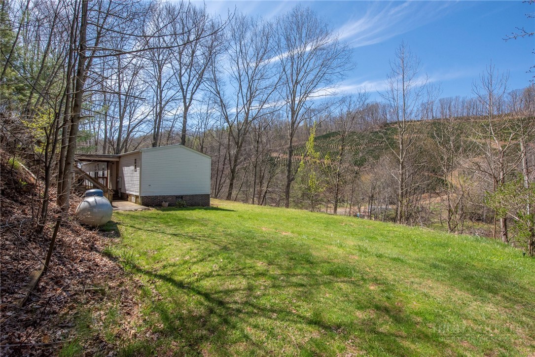 1848 West Mill Creek Road Warrensville, NC 28693 - Photo 45 of 50 a view of a backyard with large trees and wooden fence