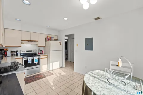 a kitchen with a refrigerator and a stove top oven