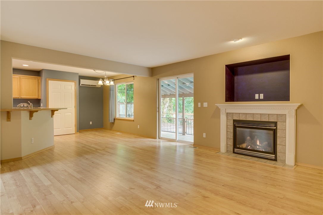 23034 12th Drive Southeast Bothell, WA 98021 - Photo 2 of 32 a view of an empty room with a fireplace and a window