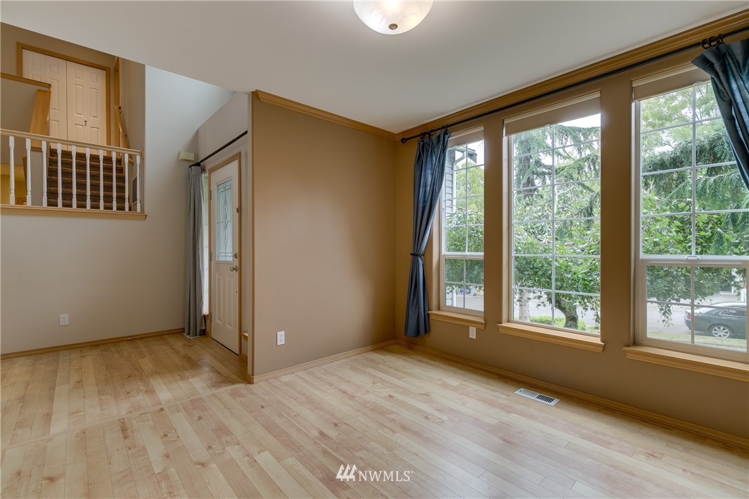 23034 12th Drive Southeast Bothell, WA 98021 - Photo 11 of 32 a view of an empty room with a window and wooden floor