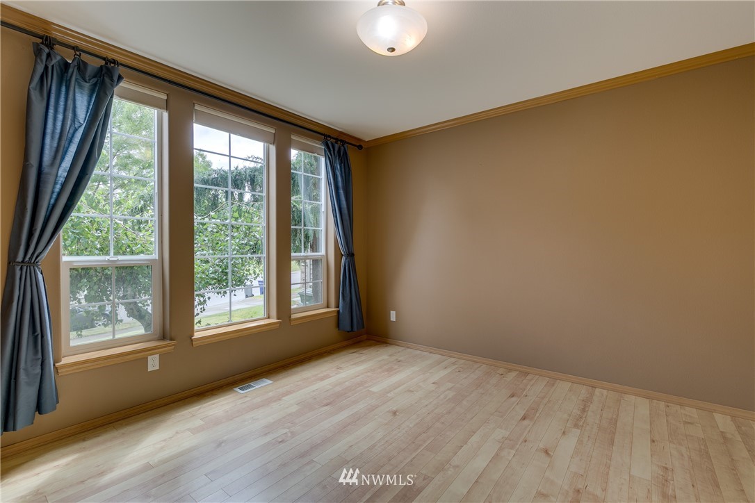 23034 12th Drive Southeast Bothell, WA 98021 - Photo 12 of 32 a view of an empty room with a window and wooden floor