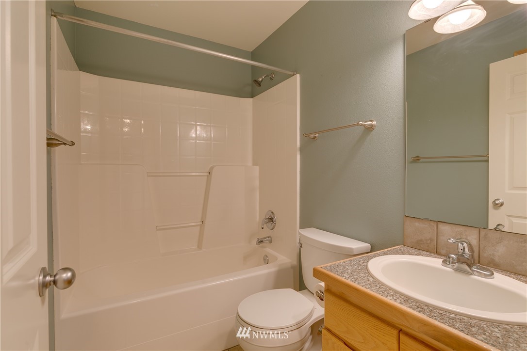 23034 12th Drive Southeast Bothell, WA 98021 - Photo 14 of 32 a bathroom with a granite countertop sink toilet and shower