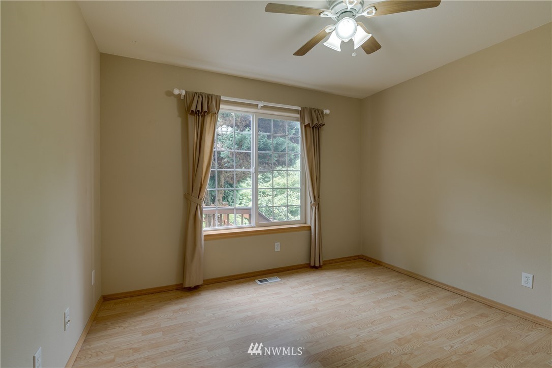 23034 12th Drive Southeast Bothell, WA 98021 - Photo 15 of 32 an empty room with chandelier fan and windows