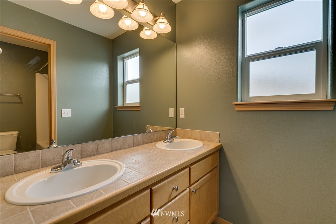 23034 12th Drive Southeast Bothell, WA 98021 - Photo 18 of 32 a bathroom with a sink and a mirror