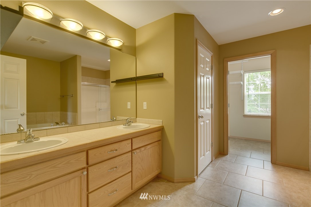 23034 12th Drive Southeast Bothell, WA 98021 - Photo 24 of 32 a bathroom with a shower sink and mirror