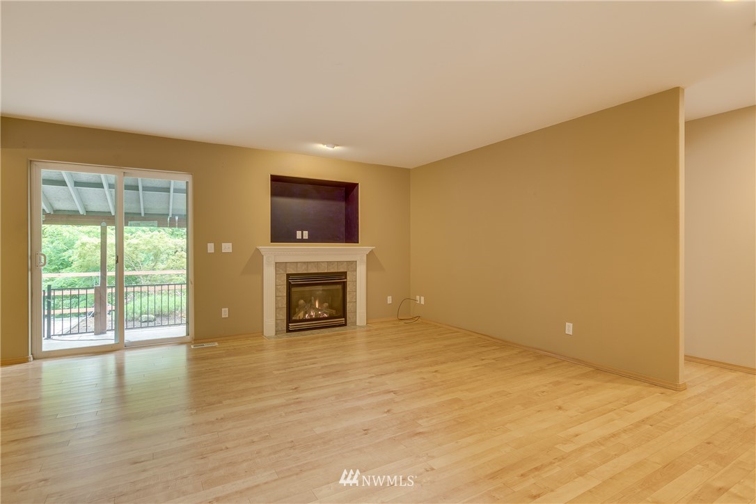 23034 12th Drive Southeast Bothell, WA 98021 - Photo 4 of 32 a view of an empty room with a fireplace and a window