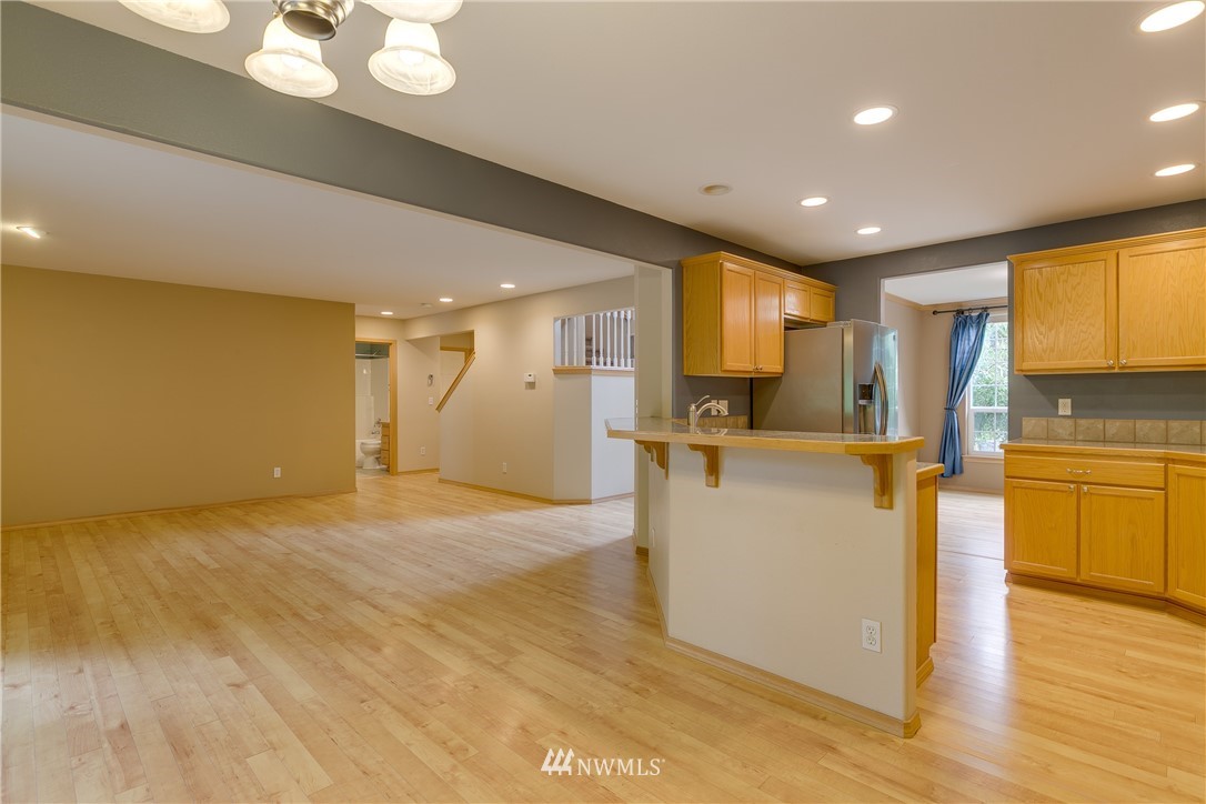 23034 12th Drive Southeast Bothell, WA 98021 - Photo 10 of 32 a view of kitchen and kitchen with furniture wooden floor and window