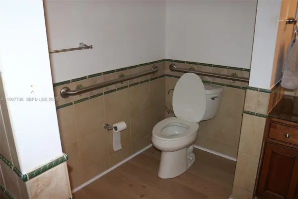 a view of a hallway with chairs and a potted plant