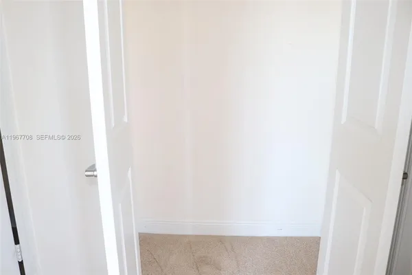 a view of an empty room with closet area