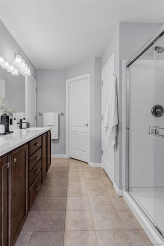a spacious bathroom with a mirror sink and shower