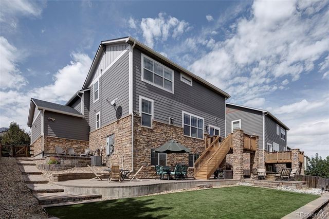 a backyard of a house with table and chairs