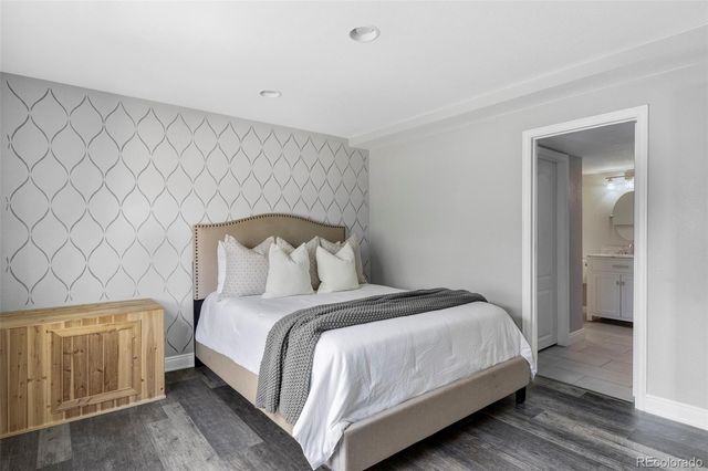 a bedroom with a bed and a night stand