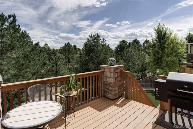 a view of balcony with wooden floor outdoor seating and city view