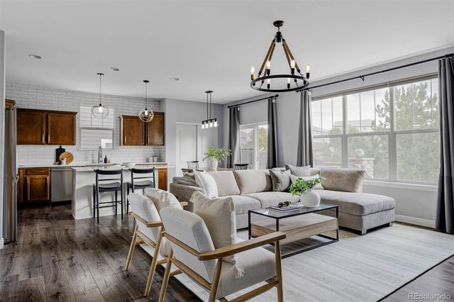 a living room with furniture ceiling fan and a window
