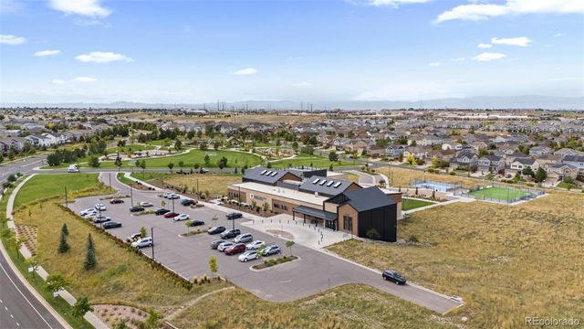 an aerial view of a house with garden space and ocean view