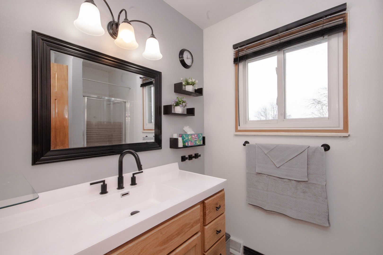 746 East Devon Avenue Roselle, IL 60172 - Photo 14 of 24 a bathroom with a sink and a mirror