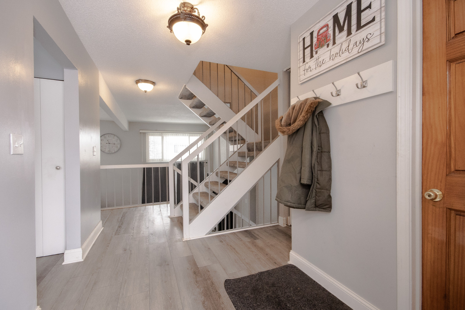 746 East Devon Avenue Roselle, IL 60172 - Photo 3 of 24 a view of entryway and hall with wooden floor