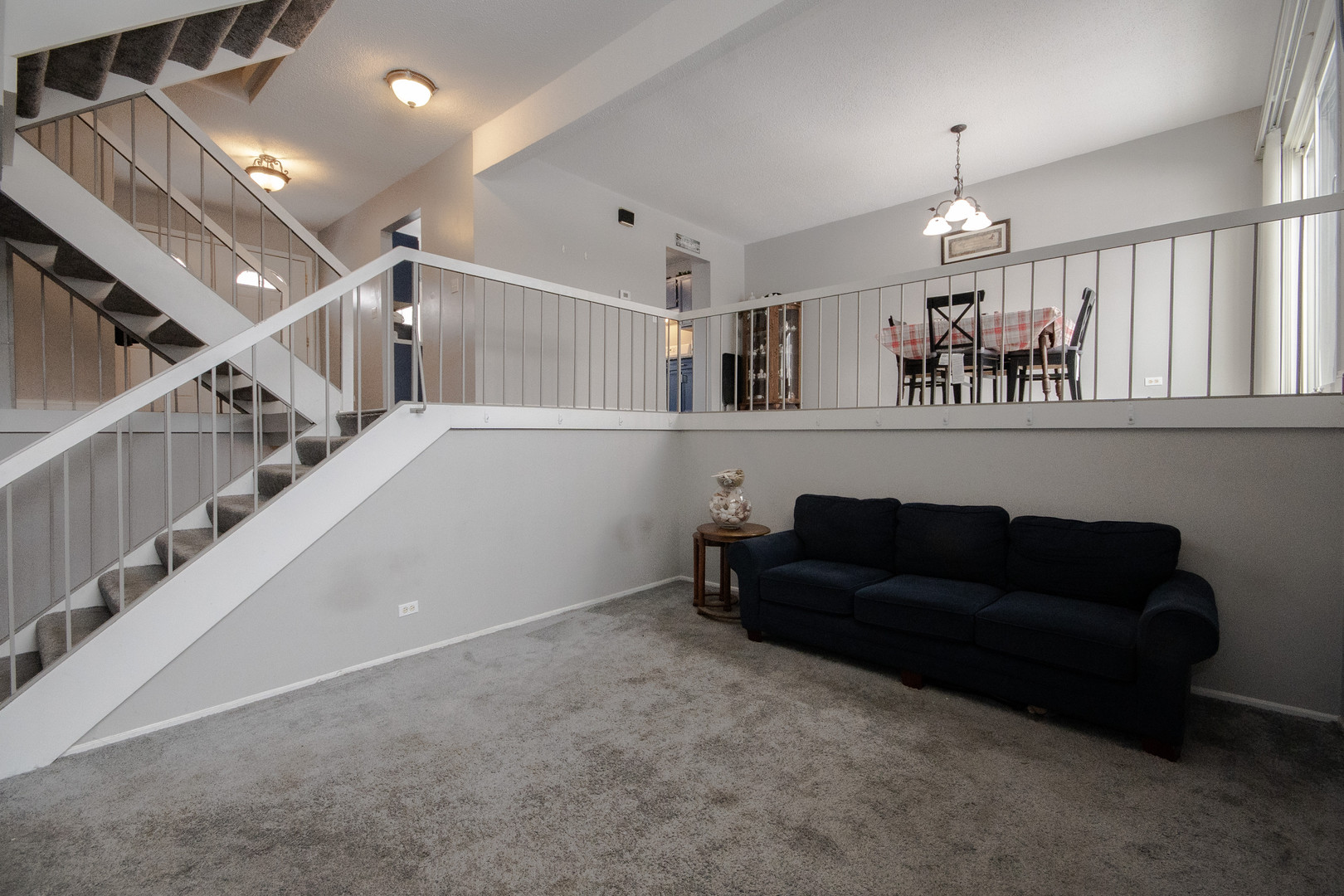 746 East Devon Avenue Roselle, IL 60172 - Photo 5 of 24 a living room with furniture and a chandelier