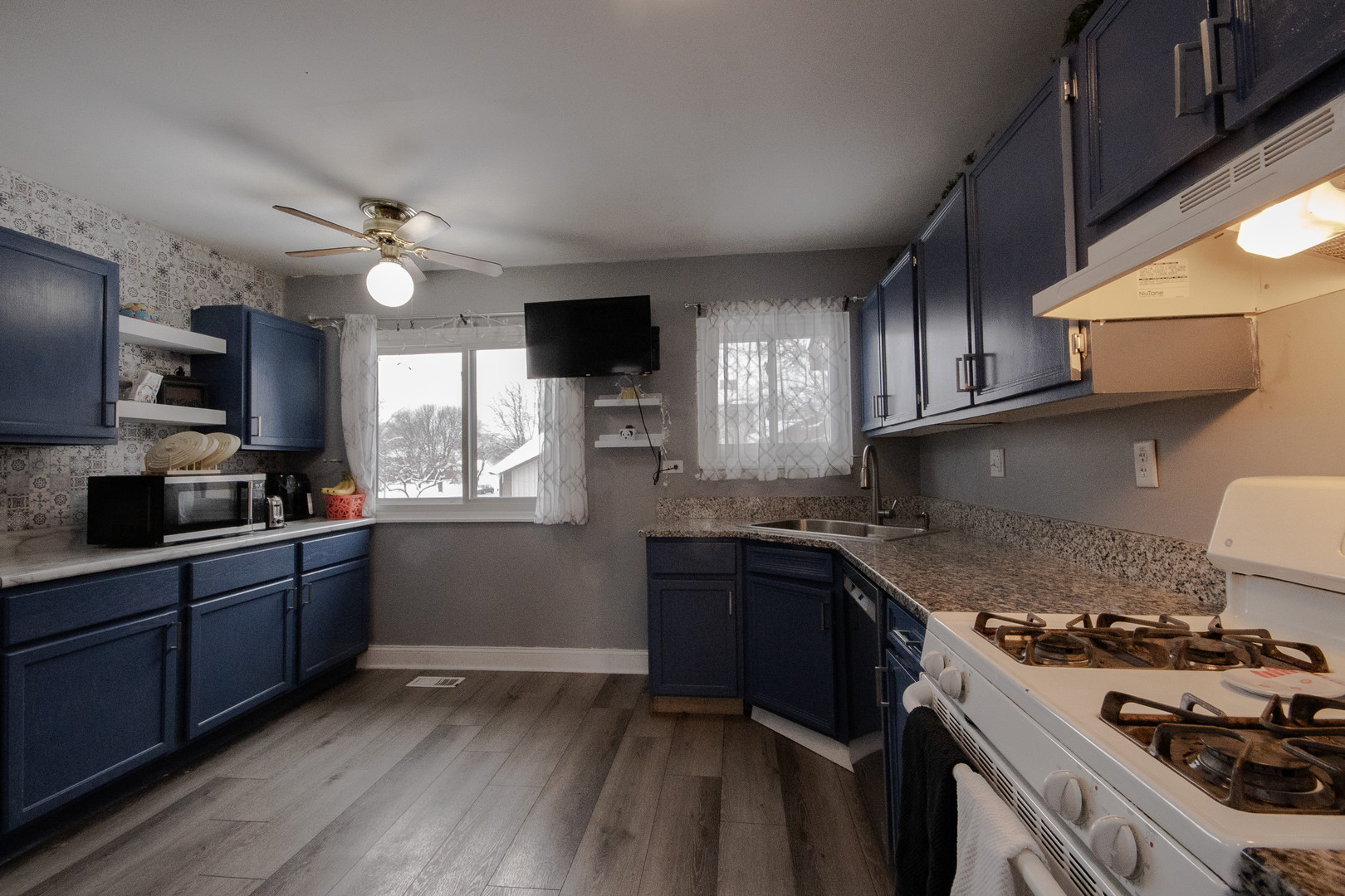 746 East Devon Avenue Roselle, IL 60172 - Photo 9 of 24 a kitchen with granite countertop a sink cabinets and stainless steel appliances