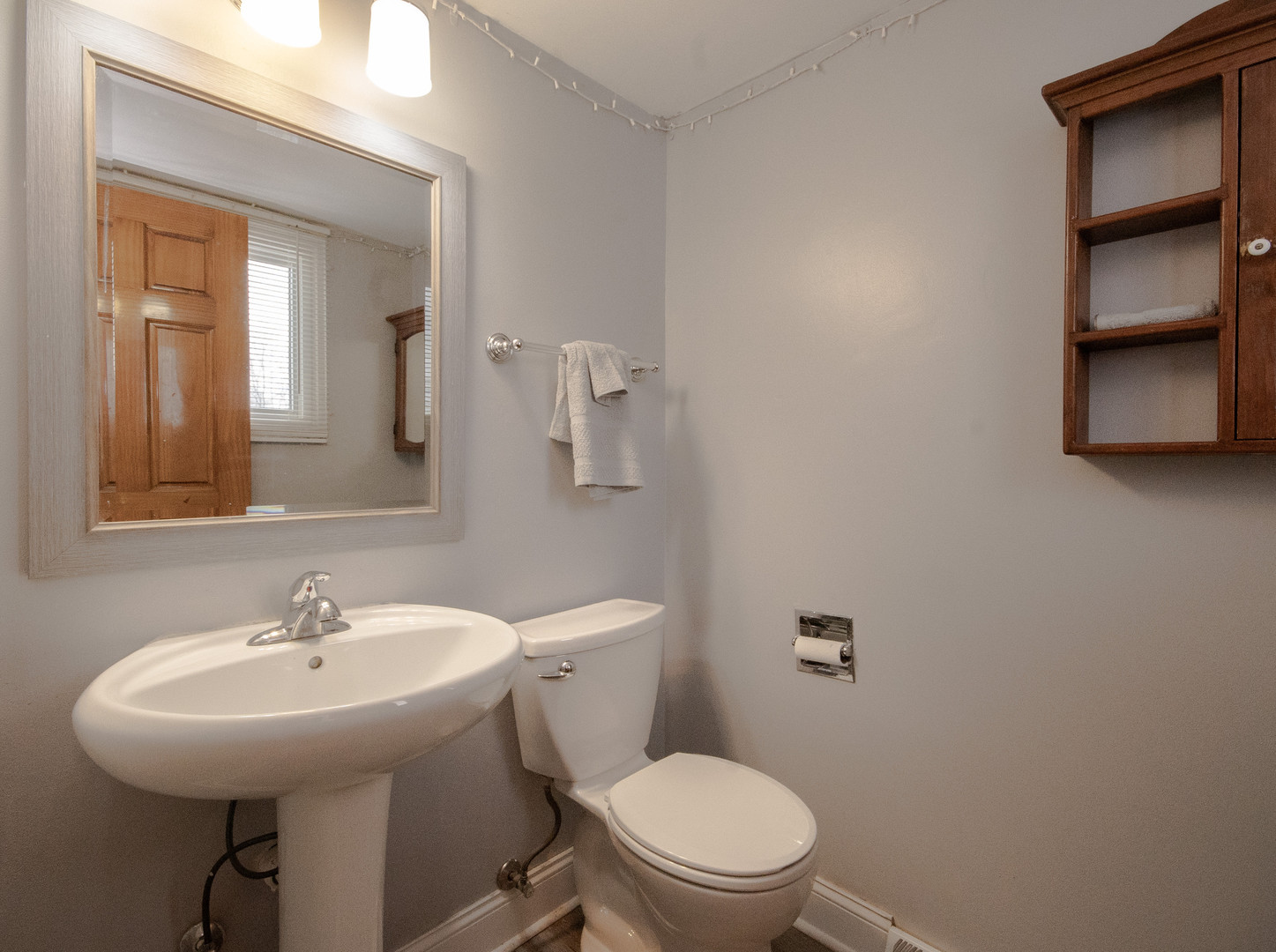 746 East Devon Avenue Roselle, IL 60172 - Photo 10 of 24 a bathroom with a sink mirror and toilet