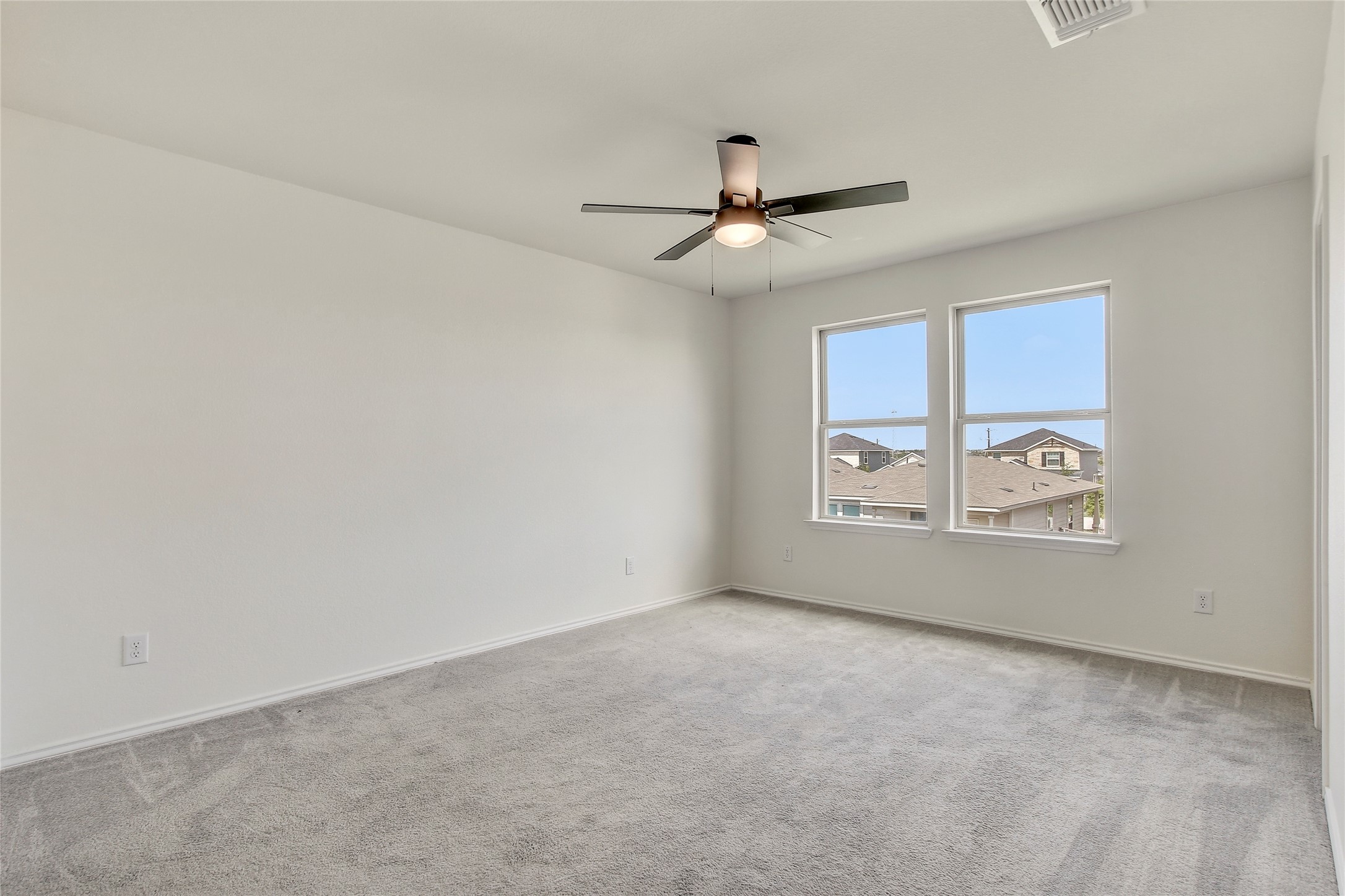 449 Stone Water Lane Jarrell, TX 76537 - Photo 11 of 18 Spacious room featuring light gray carpeting, neutral wall finishes, and a ceiling fan with integrated lighting