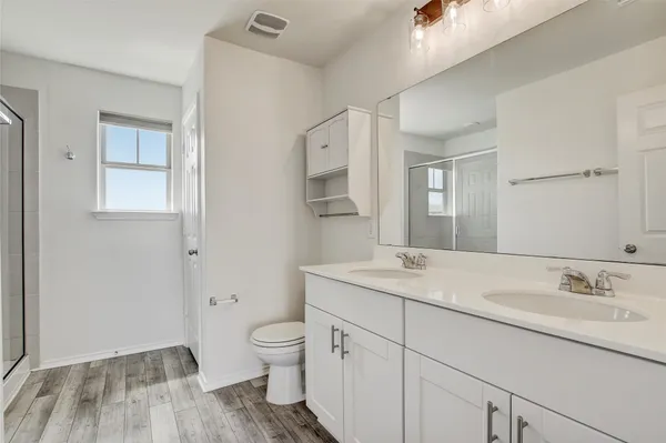 a spacious bathroom with a granite countertop sink toilet and shower