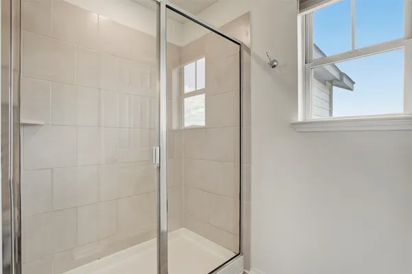 a bathroom with a glass shower door