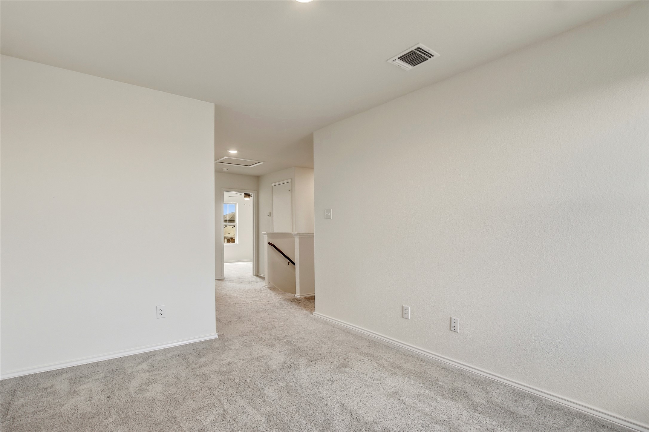 449 Stone Water Lane Jarrell, TX 76537 - Photo 15 of 18 Neutral-toned walls and plush gray carpeting characterize this interior space