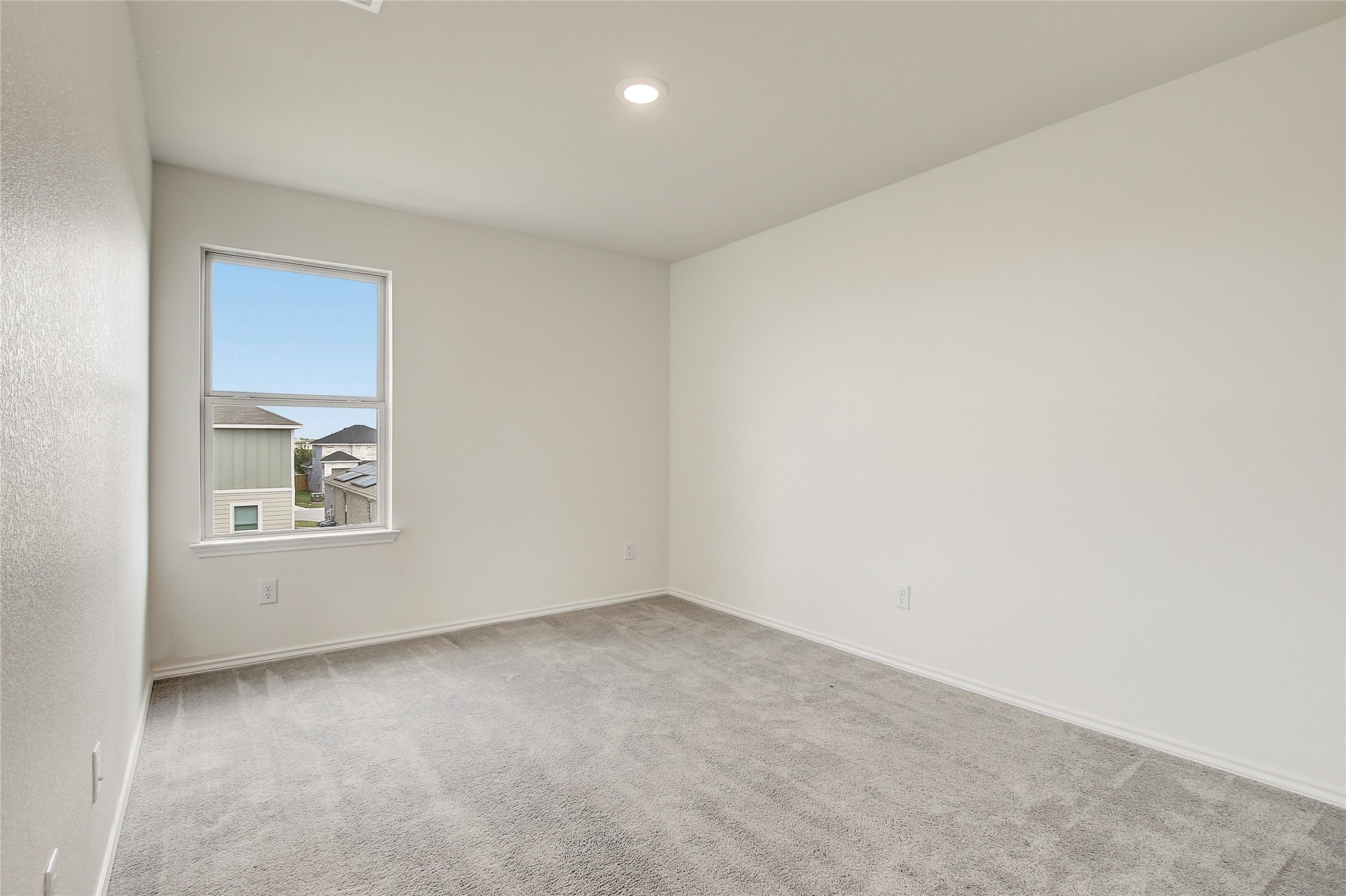 449 Stone Water Lane Jarrell, TX 76537 - Photo 16 of 18 Room featuring neutral gray carpeting and white baseboards