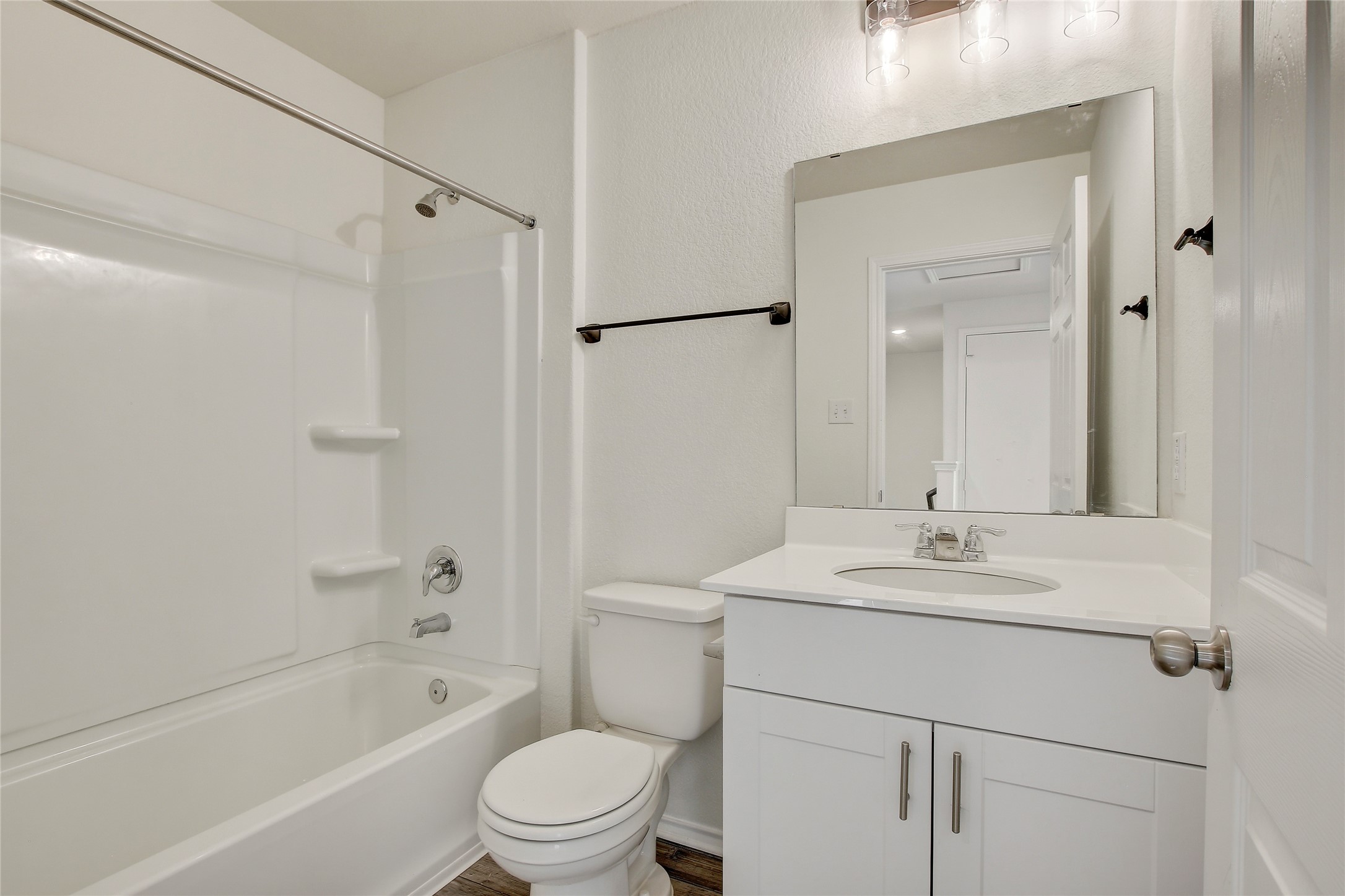 449 Stone Water Lane Jarrell, TX 76537 - Photo 17 of 18 Bathroom featuring a white vanity with a light-colored countertop, an undermount sink, and a chrome faucet